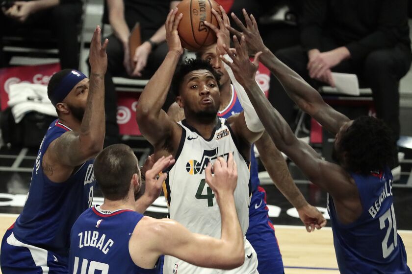 Los Angeles, CA, Wednesday, February 17, 2021 - Utah Jazz guard Donovan Mitchell (45) I surrounded by Clippers defenders in the second half at Staples Center. (Robert Gauthier/Los Angeles Times)