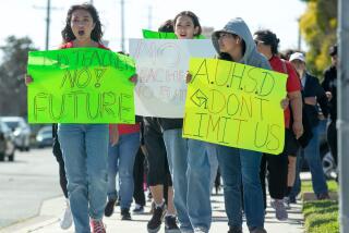 Students lead parents in a march against planned teacher layoffs within the Anaheim Union High School District.