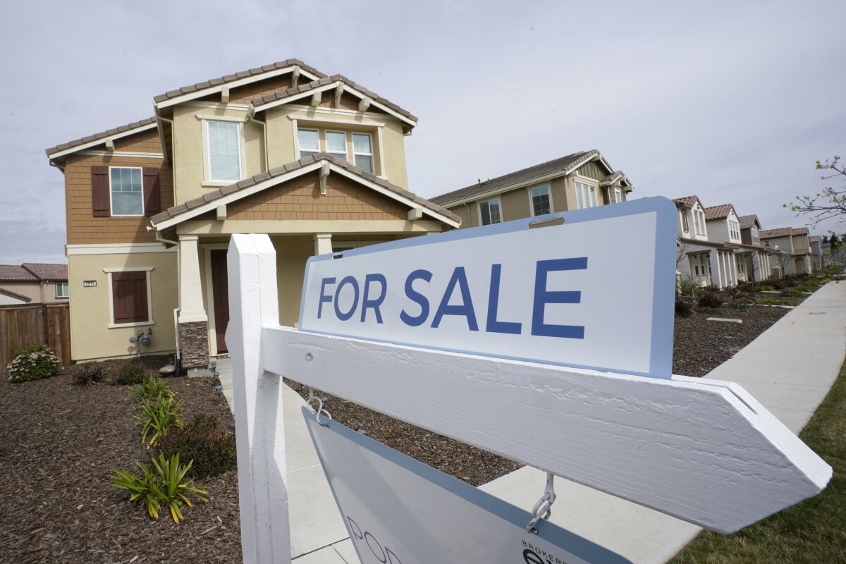  A for sale sign is posted in front of a home in Sacramento, Calif., 