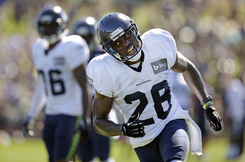 FILE - In this July 30, 2014 file photo, Seattle Seahawks' Phillip Adams runs during an NFL football camp practice in Renton, Wash. A source briefed on a mass killing in South Carolina says the gunman who killed multiple people, including a prominent doctor, was the former NFL pro. The source said that Adams shot himself to death early Thursday, April 8, 2021. (AP Photo/Elaine Thompson, File)