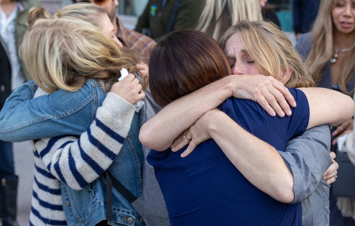 Supporters of the Iskander family hug outside the Van Nuys courtroom after the verdict 