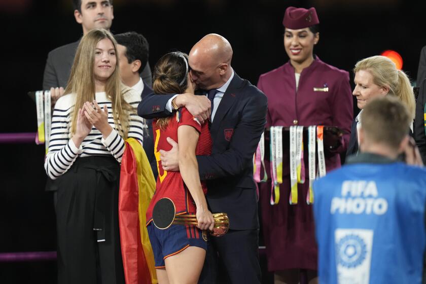 FILE - President of Spain's soccer federation, Luis Rubiales, right, hugs Spain's Aitana Bonmati on the podium following Spain's win in the final of Women's World Cup soccer against England at Stadium Australia in Sydney, Australia, Sunday, Aug. 20, 2023. At left is Spain's Princess Infanta Sofia. (AP Photo/Alessandra Tarantino, File)