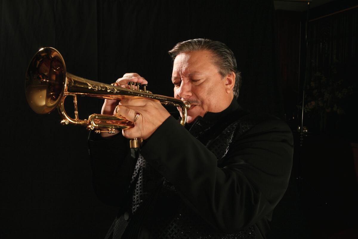 Arturo Sandoval blows into his trumpet.