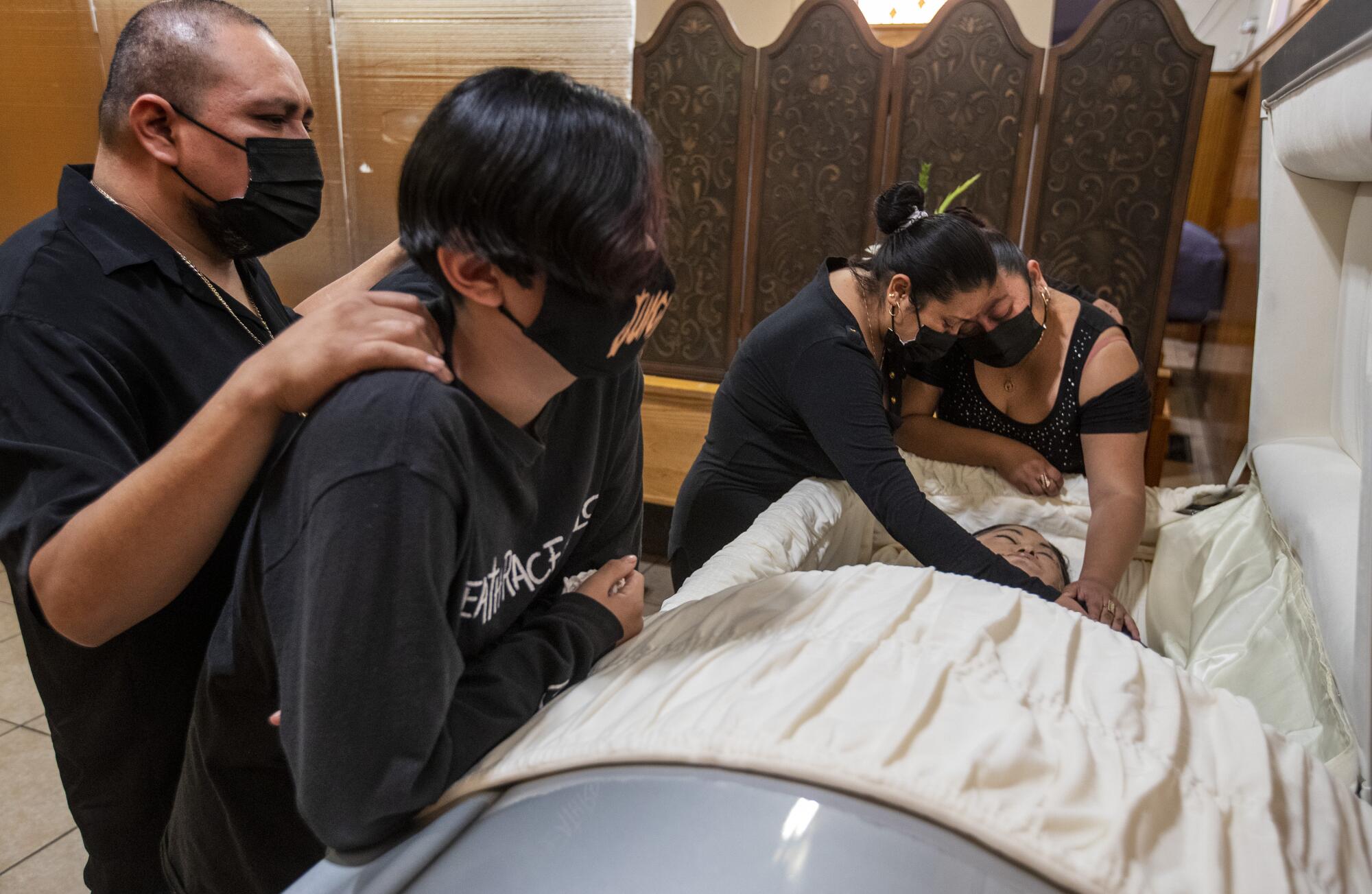 Family members gather to mourn Edith Fernandez at a viewing at Continental Funeral Home in East L.A.