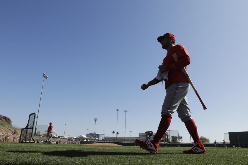 Los Angeles Angels' David Fletcher walks to the batting cage during spring training baseball practice, Monday, Feb. 17, 2020, in Tempe, Ariz. (AP Photo/Darron Cummings)