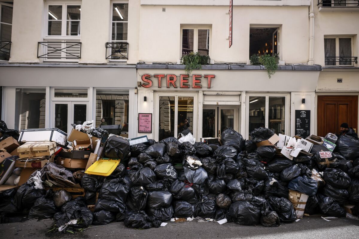 FILE - Uncollected garbage is piled up on a street in Paris, March 15, 2023, during an ongoing strike by sanitation workers. (AP Photo/Thomas Padilla, File)