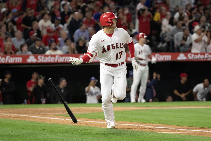 Angels designated hitter Shohei Ohtani (17) flips his bat after flying out against the Dodgers on June 20, 2023 in Anaheim.