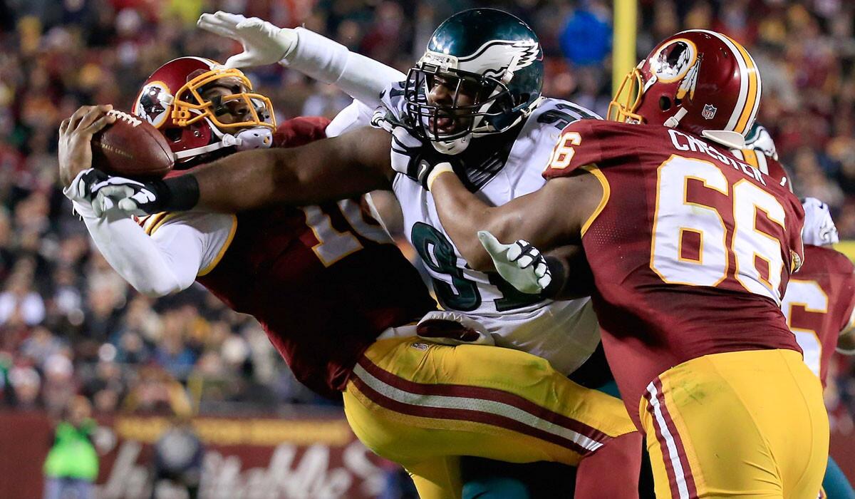 Although quarterback Robert Griffin III was sacked by Eagles defensive end Fletcher Cox on this play, the Redskins would upset Philadelphia, 27-24, on Saturday night in Washington.