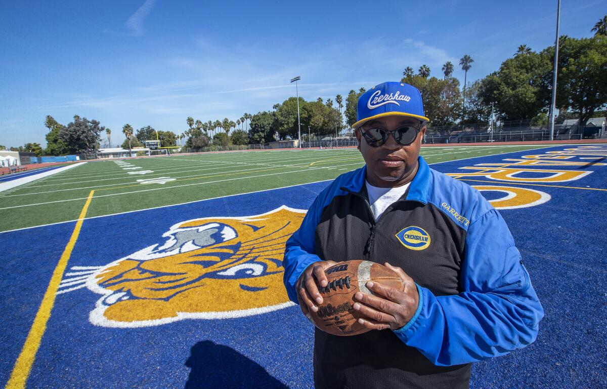 Crenshaw High football coach Robert Garrett stands on the team's football field