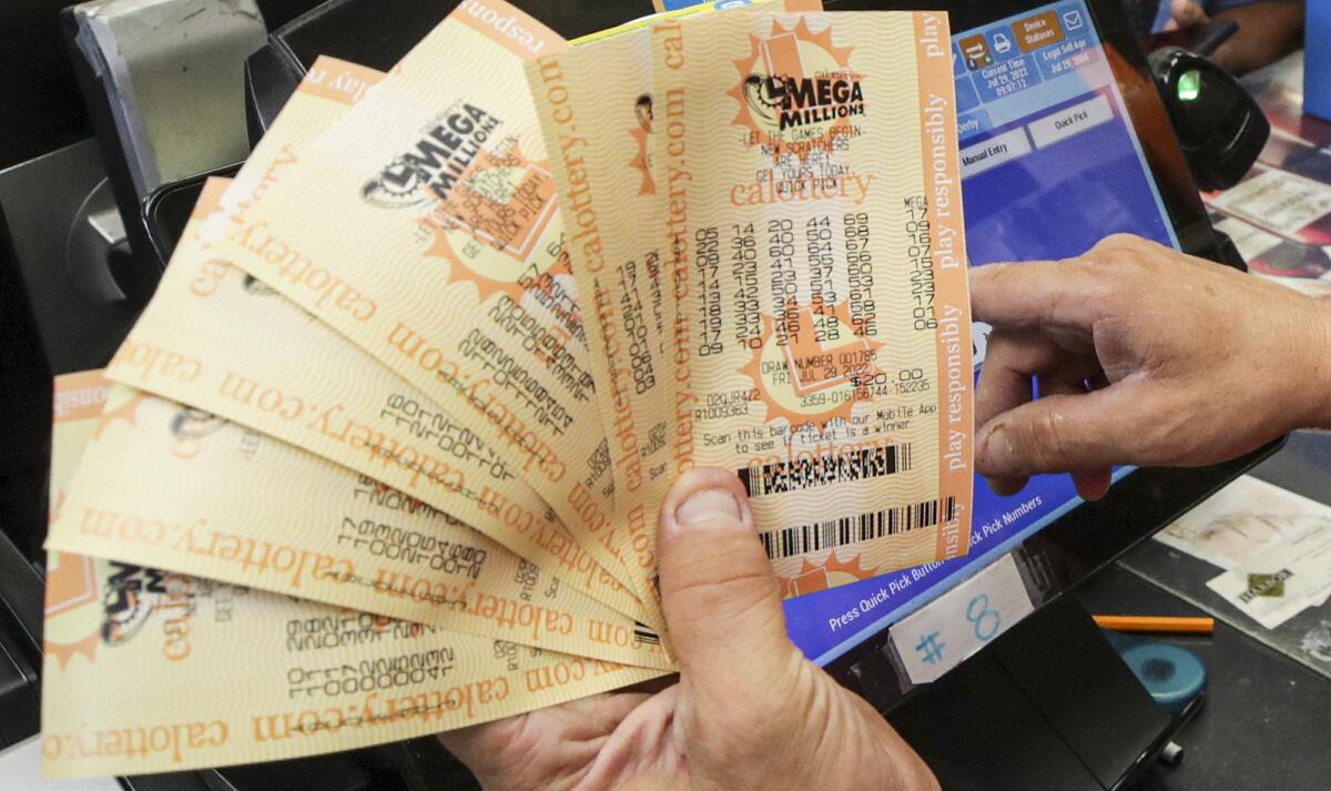  Ronald Marine, right, sells $200 worth of Mega Millions lottery to Paul Sandoval