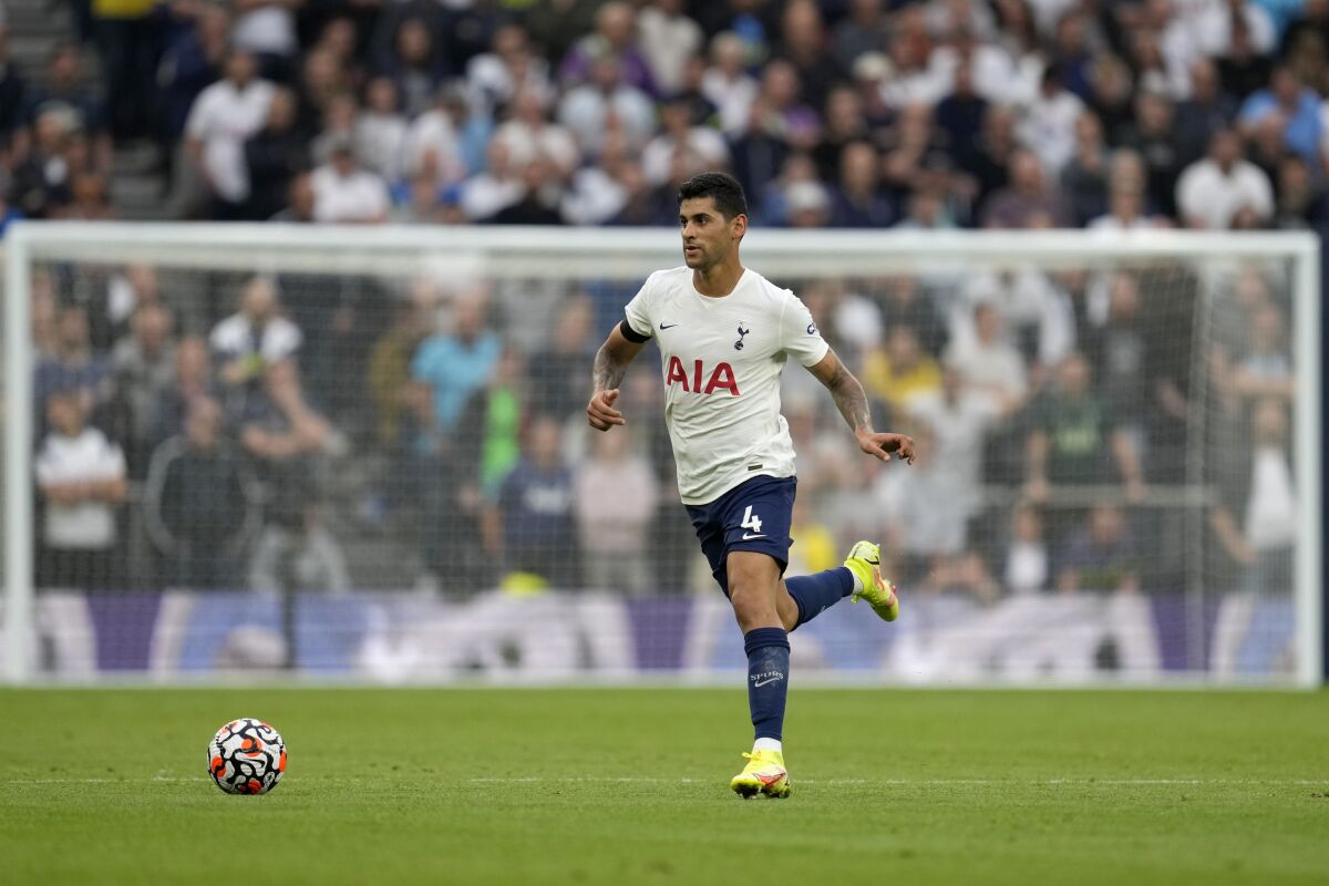 FILE - Tottenham's Cristian Romero runs with the ball during the English Premier League soccer match between Tottenham Hotspur and Chelsea at the Tottenham Hotspur Stadium in London, England, on Sept. 19, 2021. Tottenham says center back Cristian Romero will be sidelined until at least January because of a “serious” hamstring injury. The Argentina defender sustained the injury during a World Cup qualifier against Brazil two weeks ago. Tottenham manager Antonio Conte says “we’ll have to wait until January, February” for his return. (AP Photo/Matt Dunham, File)