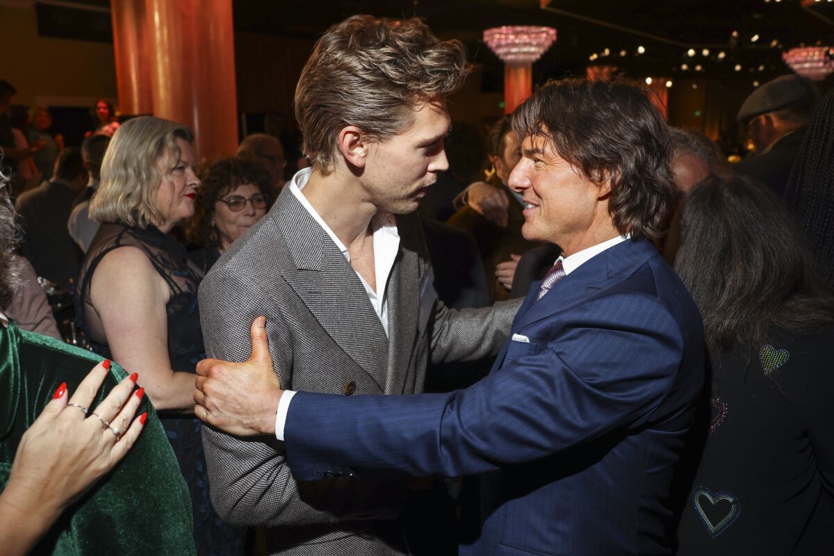 "Elvis" star Austin Butler and "Top Gun: Maverick" star Tom Cruise meet at the Oscar nominees luncheon on Feb. 13