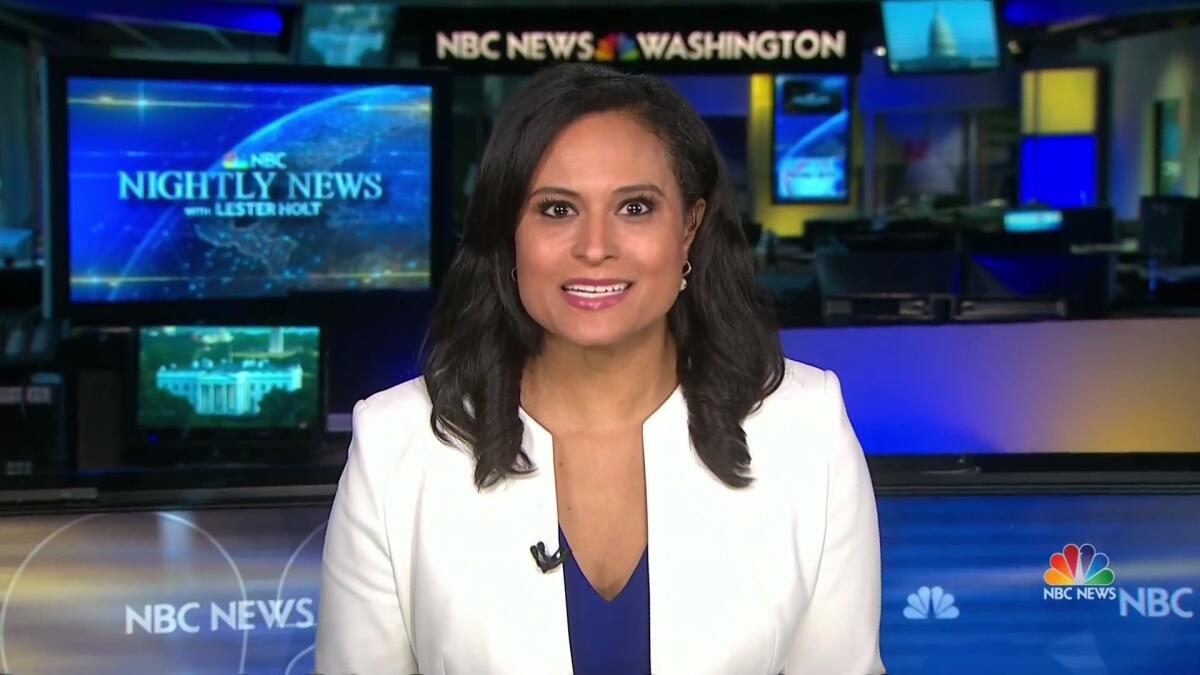 Kristen Welker sits with several TV screens and NBC logos behind her.