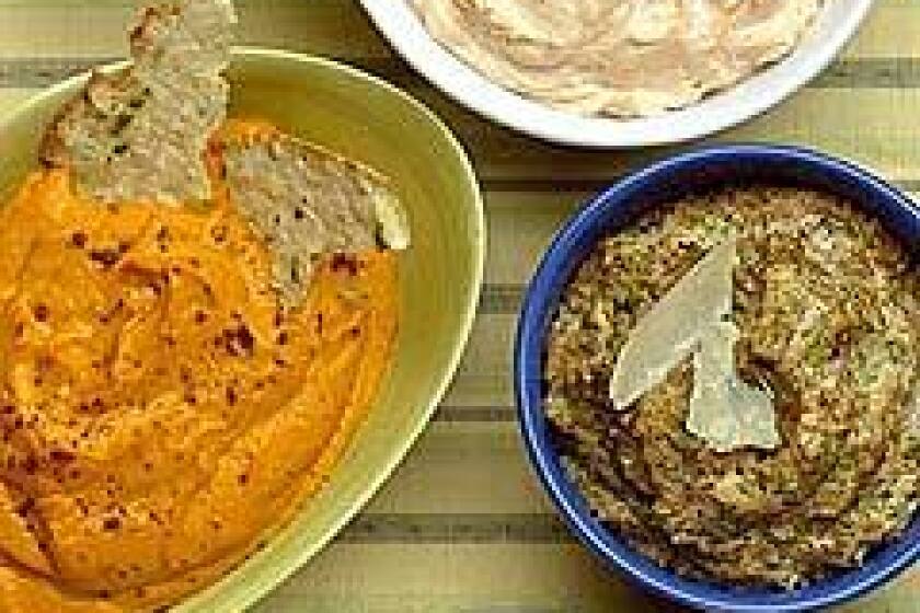 Clockwise from top: Luxurious tarama or salmon spread, Christmas lima bean spread, rustic almond tapenade and five-spice carrot-cashew spread can all be made ahead. Keep the breadbox stocked too.