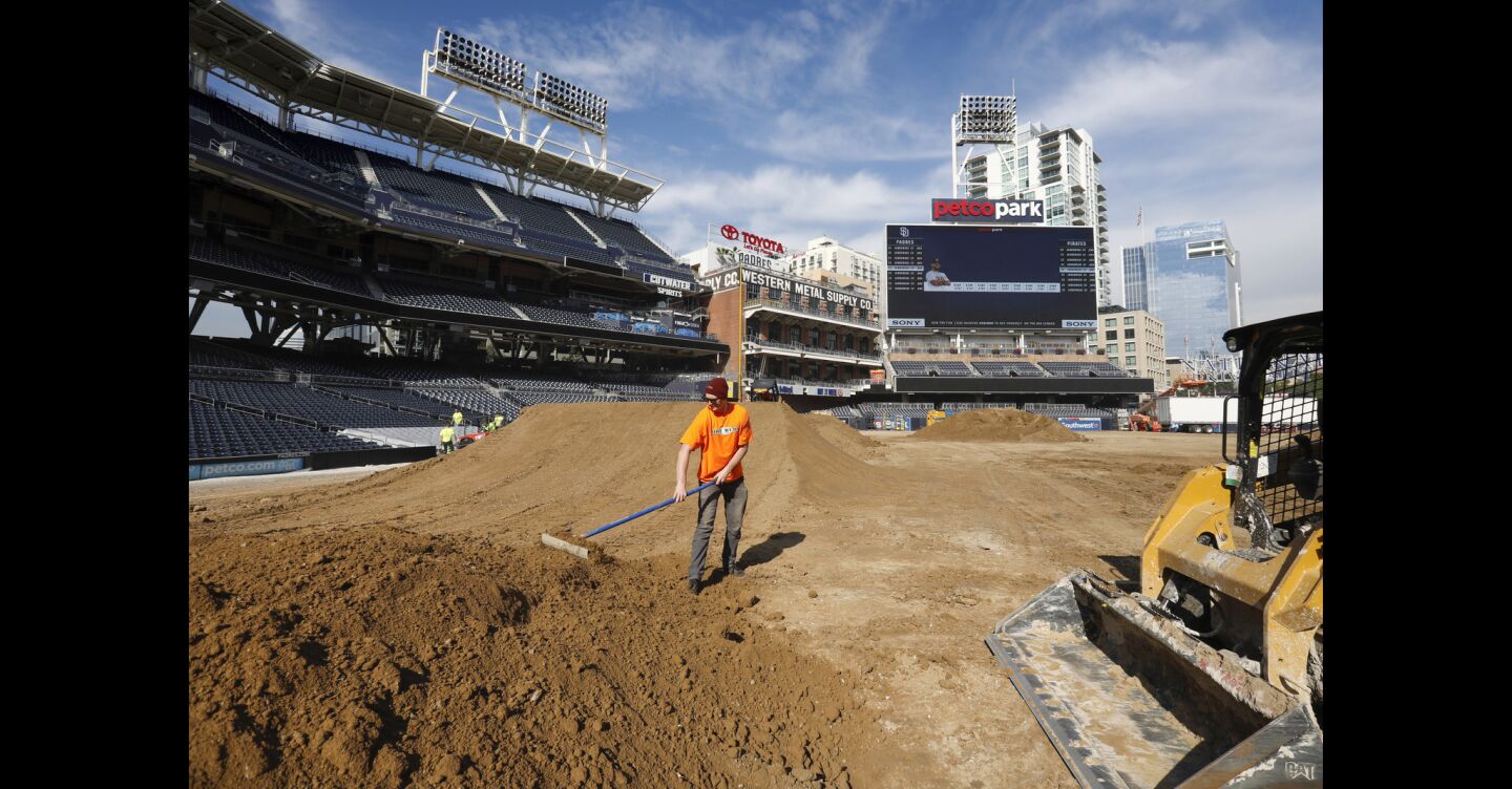Cameron Tyler smoothes out dirt on one of the jumps on the racetrack being created out of 26 million pounds of dirt, on the baseball field, at Petco Park, in preparation for the Monster Energy Supercross, to be held Saturday, February 2. Padres fans need not worry about the field. After the supercross is over, a brand new field will be installed, and ready for the 2019 season.