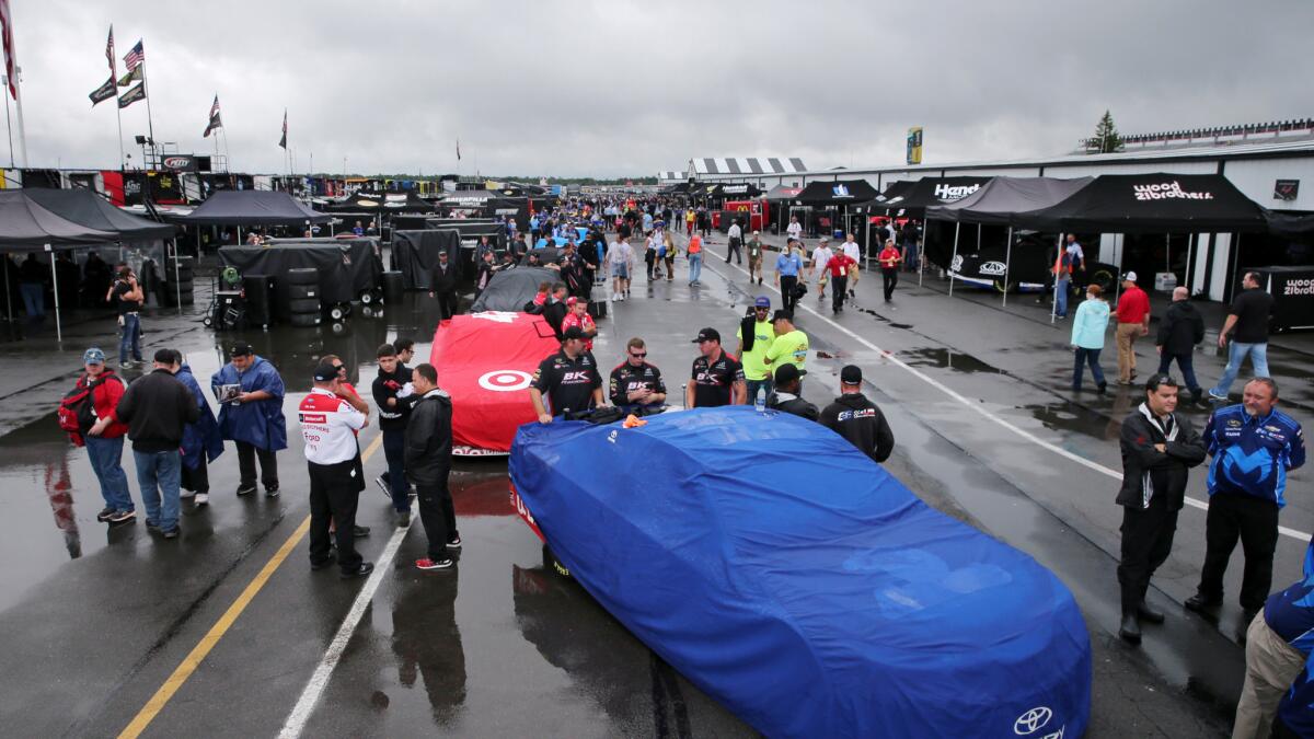 Stock cars are lined up for inspection at Pocono Raceway on Sunday.