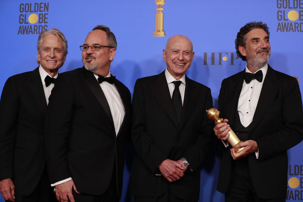 The team behind "The Kominsky Method" celebrates its multiple Globe wins backstage in the trophy room.
