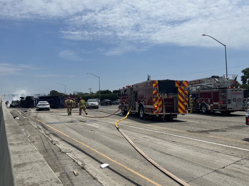 Fire crews respond to the 405 Freeway, south of Bristol Avenue, where a chain-reaction collision caused a fire.