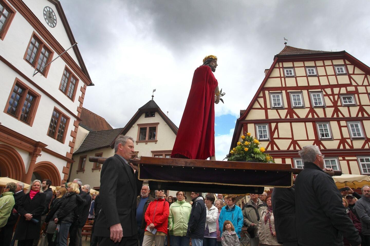 Members of a craftsmen guild carry a statue of Jesus Christ during a Good Friday procession in Lohr am Main, western Germany.