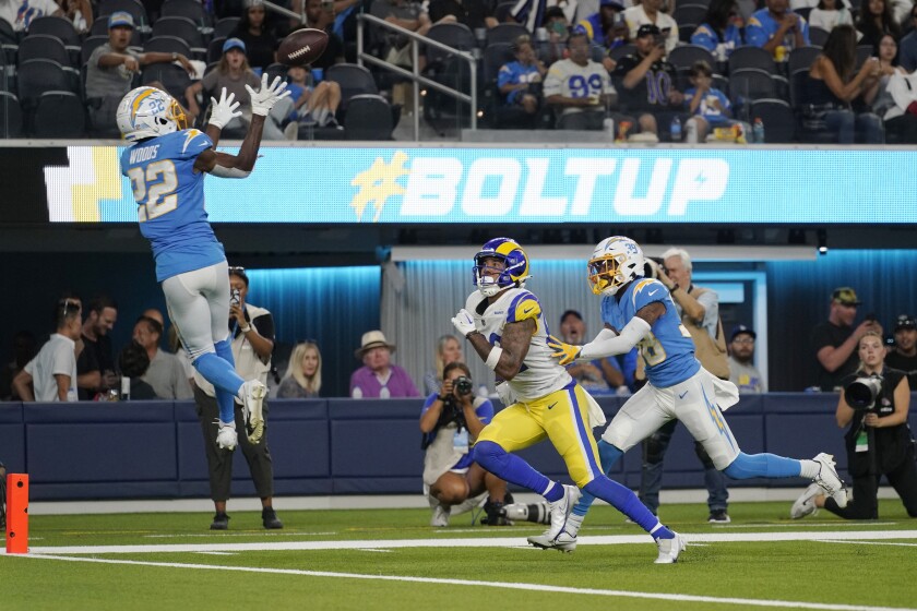The Chargers' JT Woods leaps to intercept the ball.