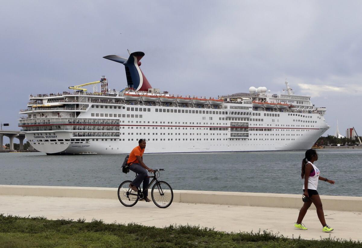 In this Friday, July 24, 2015 photo, the Carnival Ecstasy cruise ship leaves the Port of Miami. With Florida on pace to host a record 100 million visitors this year, the state's tourism infrastructure is being challenged like never before. Florida's four large-hub airports and five major seaports are undergoing billions of dollars in renovations and construction, but some experts says Florida will have to adapt to even further increases in demand to remain competitive. Tourism is the state's biggest industry. (AP Photo/Lynne Sladky)