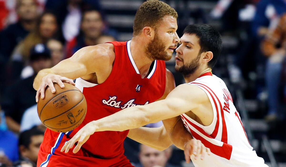 Rockets forward Kostas Papinikolaou tries to strip the ball from Clippers forward Blake Griffin in the first half of their game Friday night in Houston.