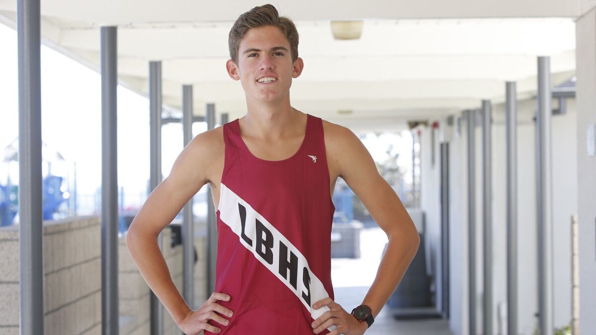 Laguna Beach High cross-country runner Sebastian Fisher established a school record with a time of 14:38.8 in the Woodbridge Invitational at Norco's SilverLakes Sports Park on Sept. 15.