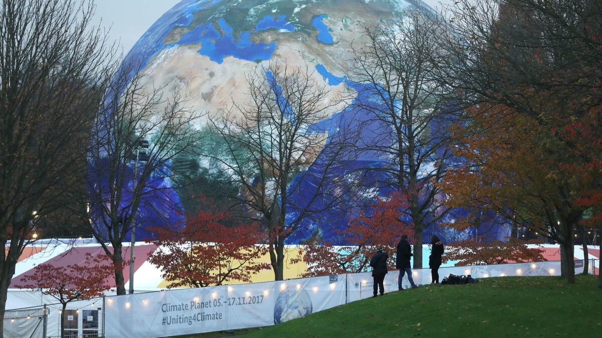 People walk past the "Climate Planet," an exhibition sponsored by the German Federal Ministry of Economic Cooperation and Development, near the plenary halls of the COP 23 United Nations Climate Change Conference on Nov. 6 in Bonn.