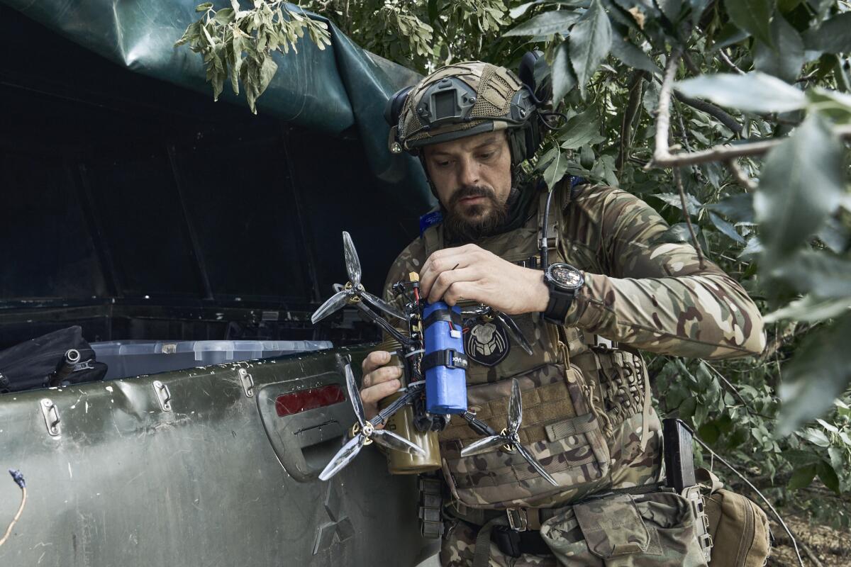 Ukrainian soldier preparing a drone