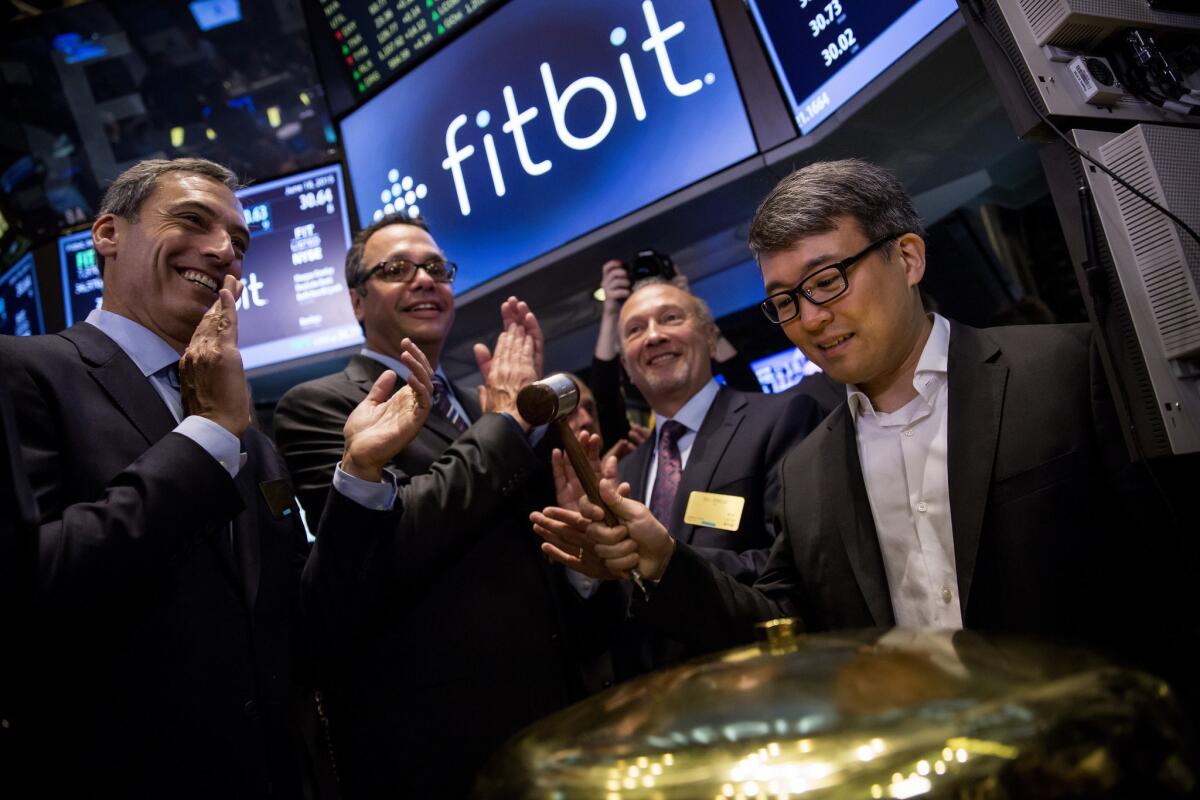 Fitbit Chief Executive James Park rings a ceremonial bell for the company's IPO debut on the floor of the New York Stock Exchange.