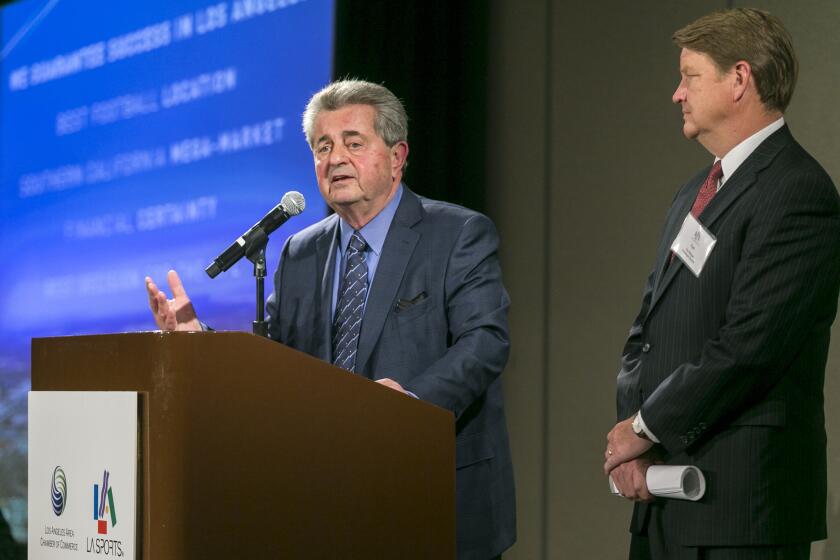 Former NFL executive Carmen Policy, left, comments on a proposed $1.7-billion NFL football stadium during a lunch sponsored by the Los Angeles Sports Council in downtown Los Angeles on Monday.