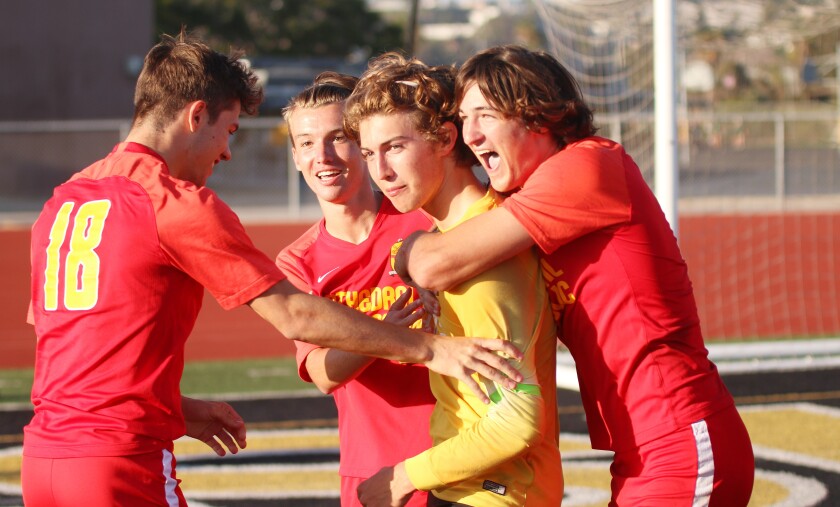 Teammates celebrate victory with keeper Brady Bachman.