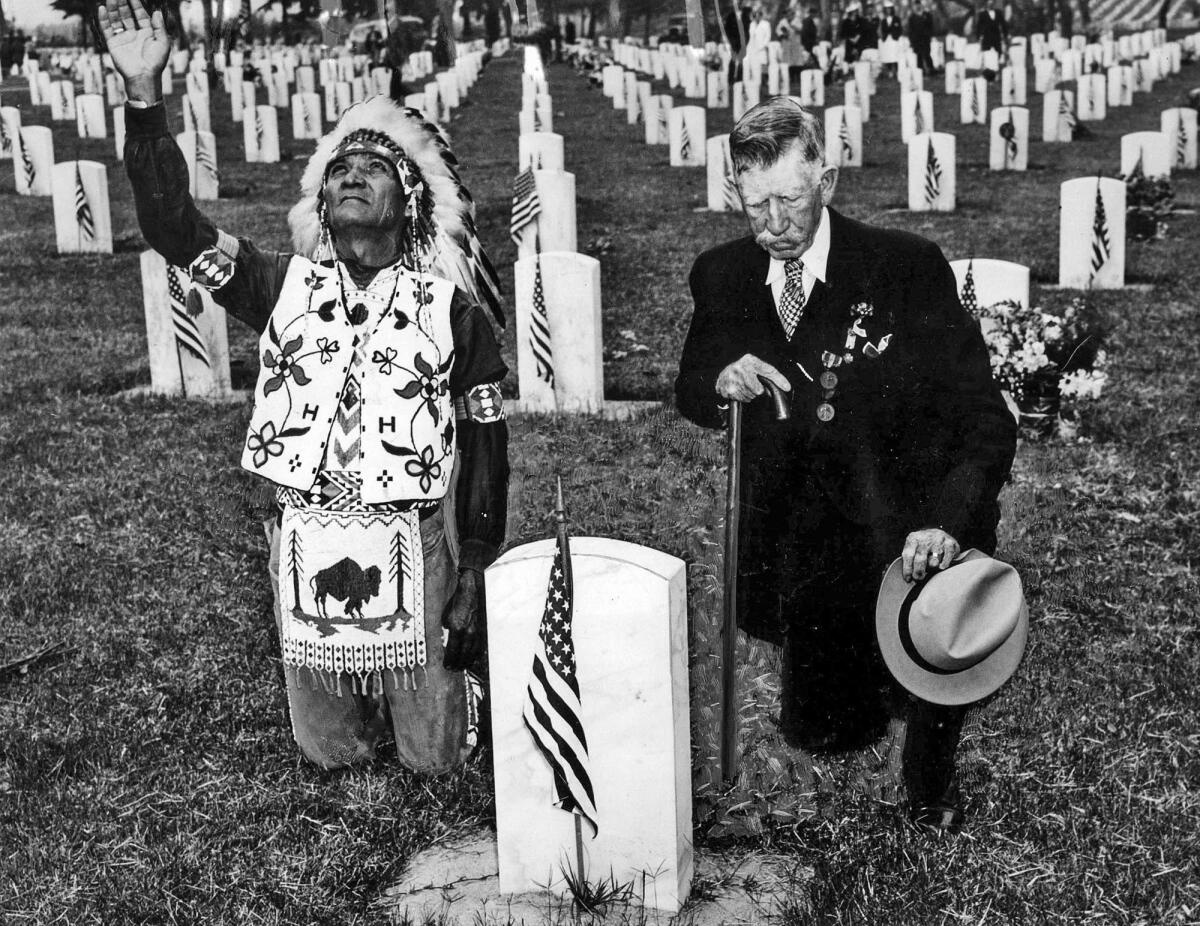 May 30, 1939: World War I veteran Joe Adgar, left, and Spanish-American War veteran P.P. Finnerin kneel by the graves of comrades at the Sawtelle Veterans Cemetery.