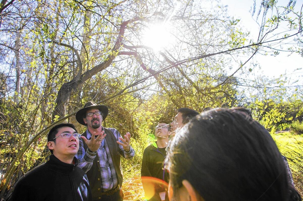 Bo Glover, executive director of the Environmental Nature Center in Newport Beach, gives a tour to a student delegation from Experimental High School in Beijing on Wednesday.