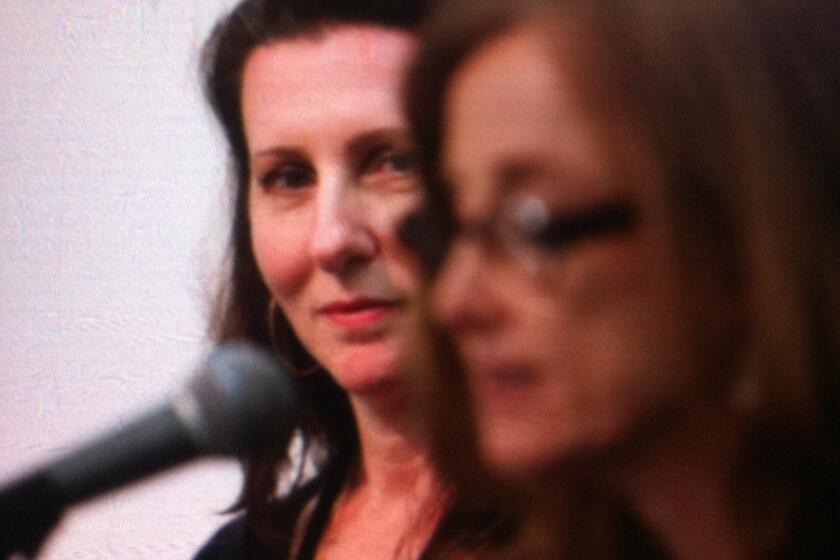 Author Bronwen Hruska, left, listens to Mona Simpson as she reads a poem about motherhood during a panel on the second day of the 2013 LA Times Book Festival.