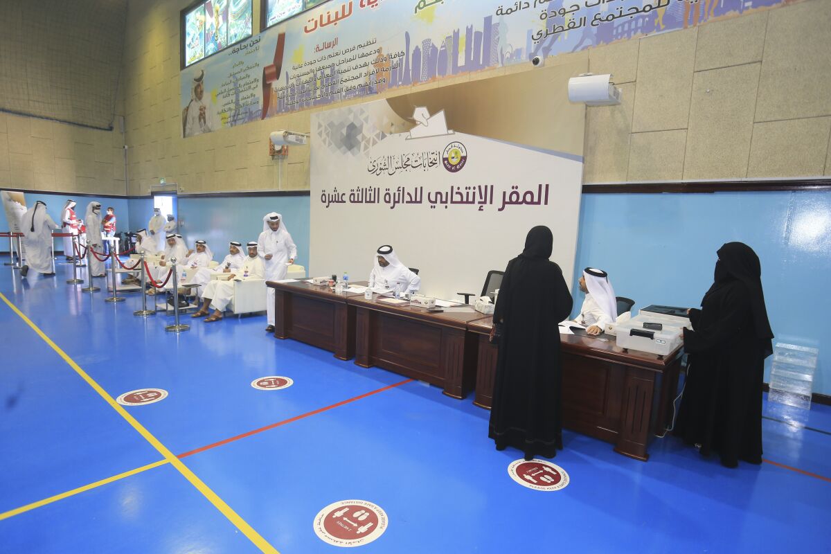 Qataris arrive to vote in legislative elections in Doha, Qatar, Saturday, Oct. 2, 2021. For the first time citizens will elect two-thirds of Shura council while emir will appoint the remaining 15 members. (AP Photo/Hussein Sayed)