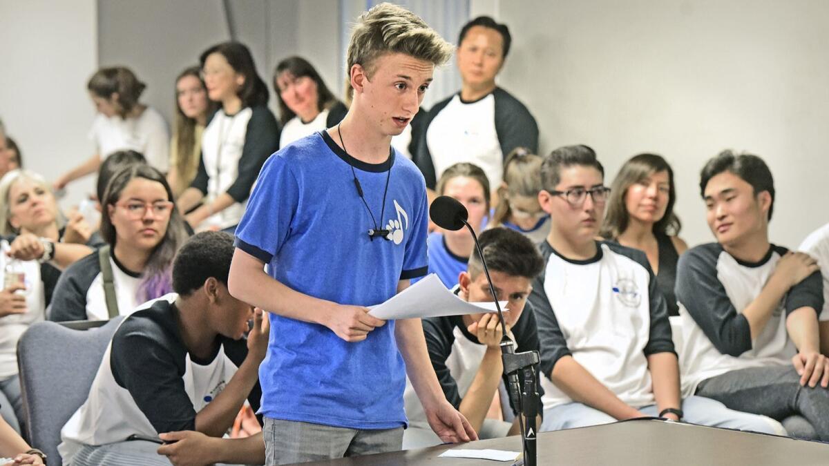William Rodriguez, 16, speaks about the positive camaraderie of the choir members during a special meeting held at the Burbank Unified School District office on Wednesday.