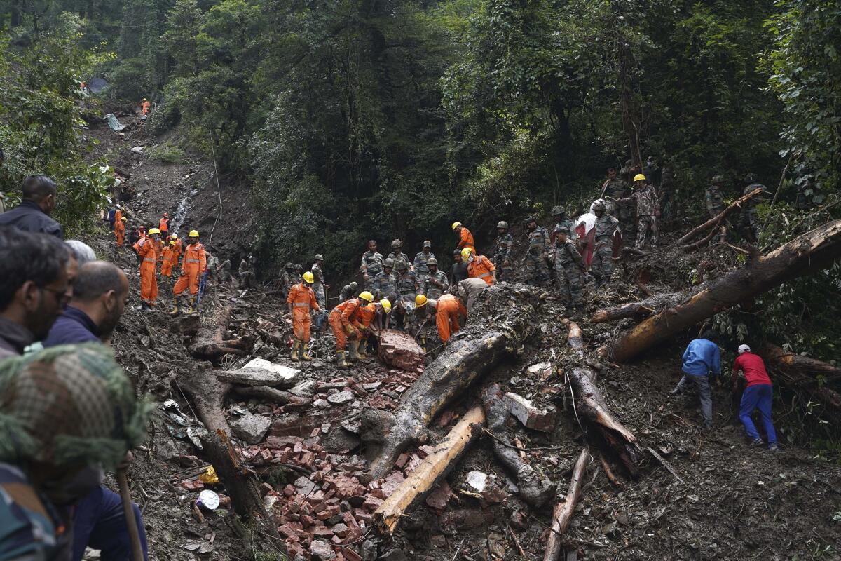 Rescue workers searching for survivors in debris of landslide