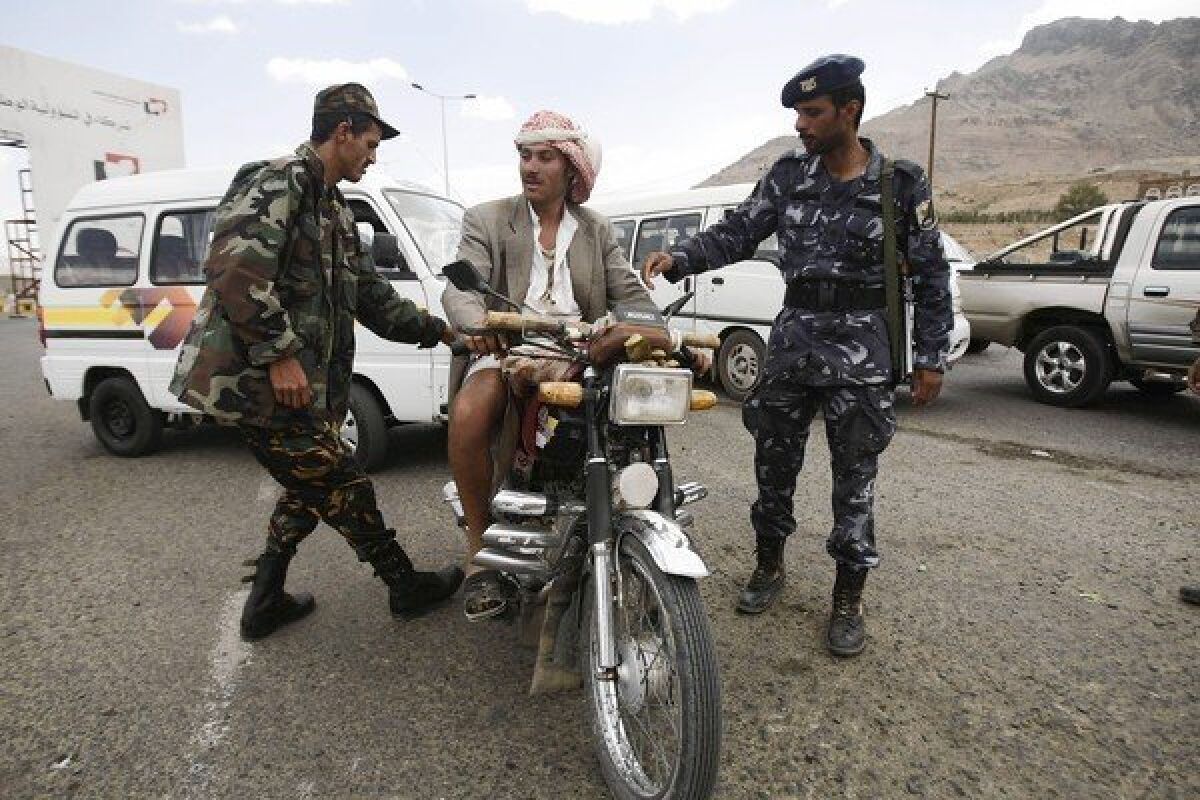 Yemeni soldiers stop a motorcyclist at a checkpoint in Sana, the capital. Security was stepped up after the Oct. 6 killing of a German Embassy guard and the kidnapping of a UNICEF employee.