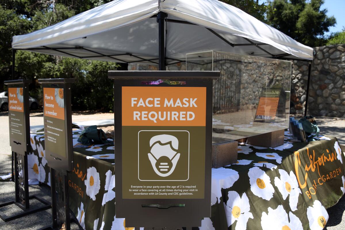 Signage alerts people that masks are required in the California Botanic Garden