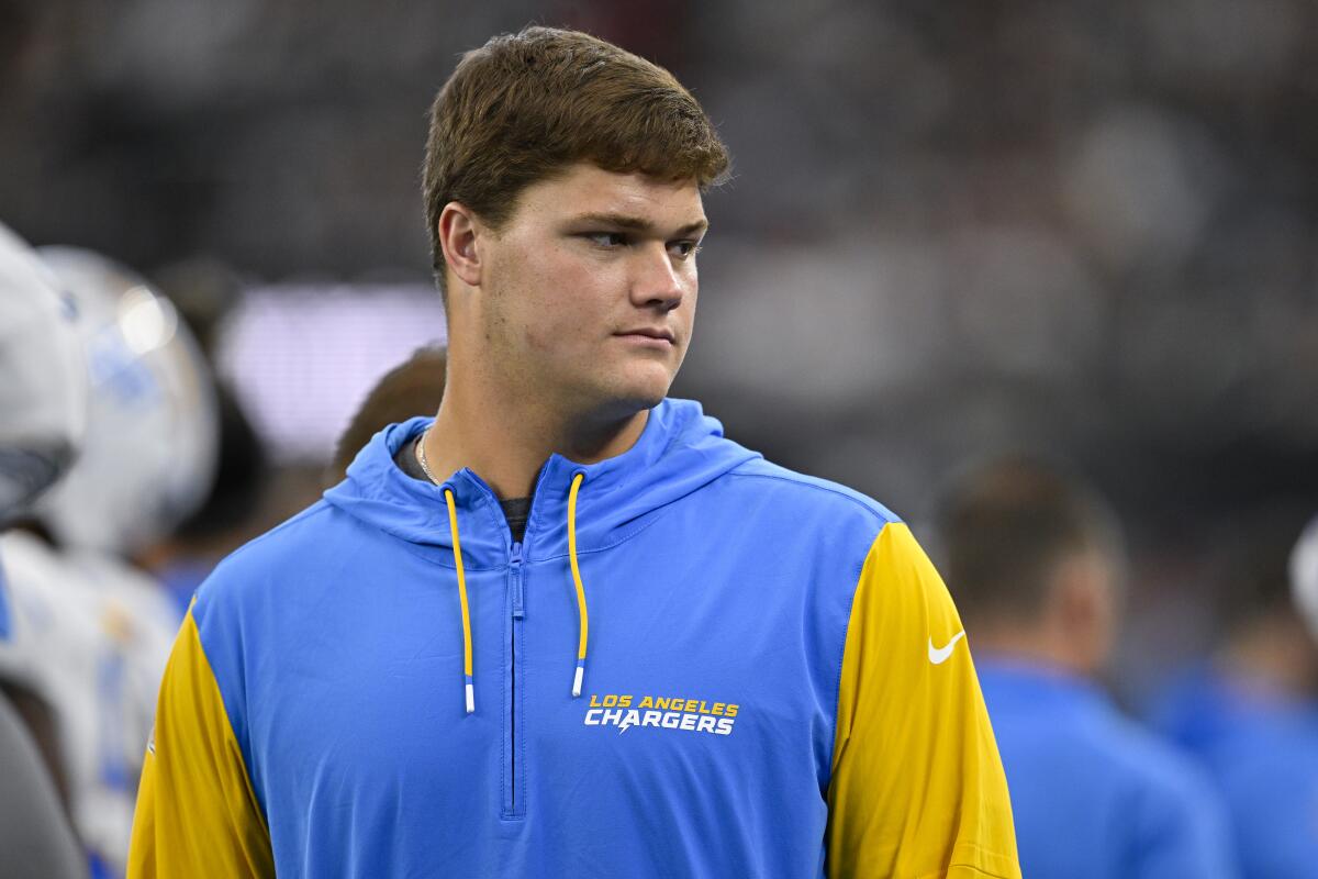  Chargers offensive tackle Joe Alt walks the sidelines a preseason game.