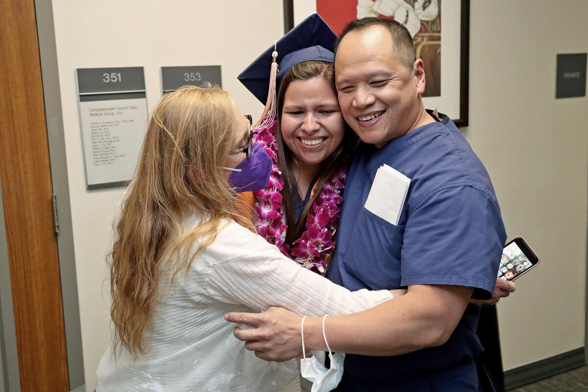  Judit Ramirez shares a hug with Dr. Thang Nguyen and Adrienne Feilden at Fountain Valley Regional Hospital Thursday, May 26.