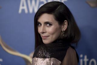 Jamie-Lynn Sigler smiles while turning her head over her left shoulder and wearing a sparkling top