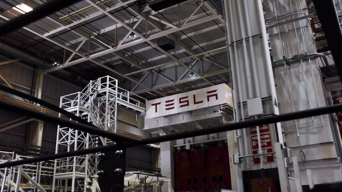 A metal stamping press at Tesla's Fremont plant.