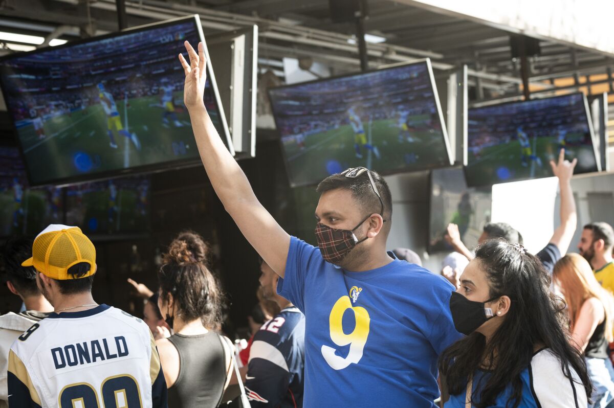 Nishit Dani, a Rams fan from Philadelphia, celebrates a Super Bowl touchdown outside Tom's Watch Bar at L.A. Live.
