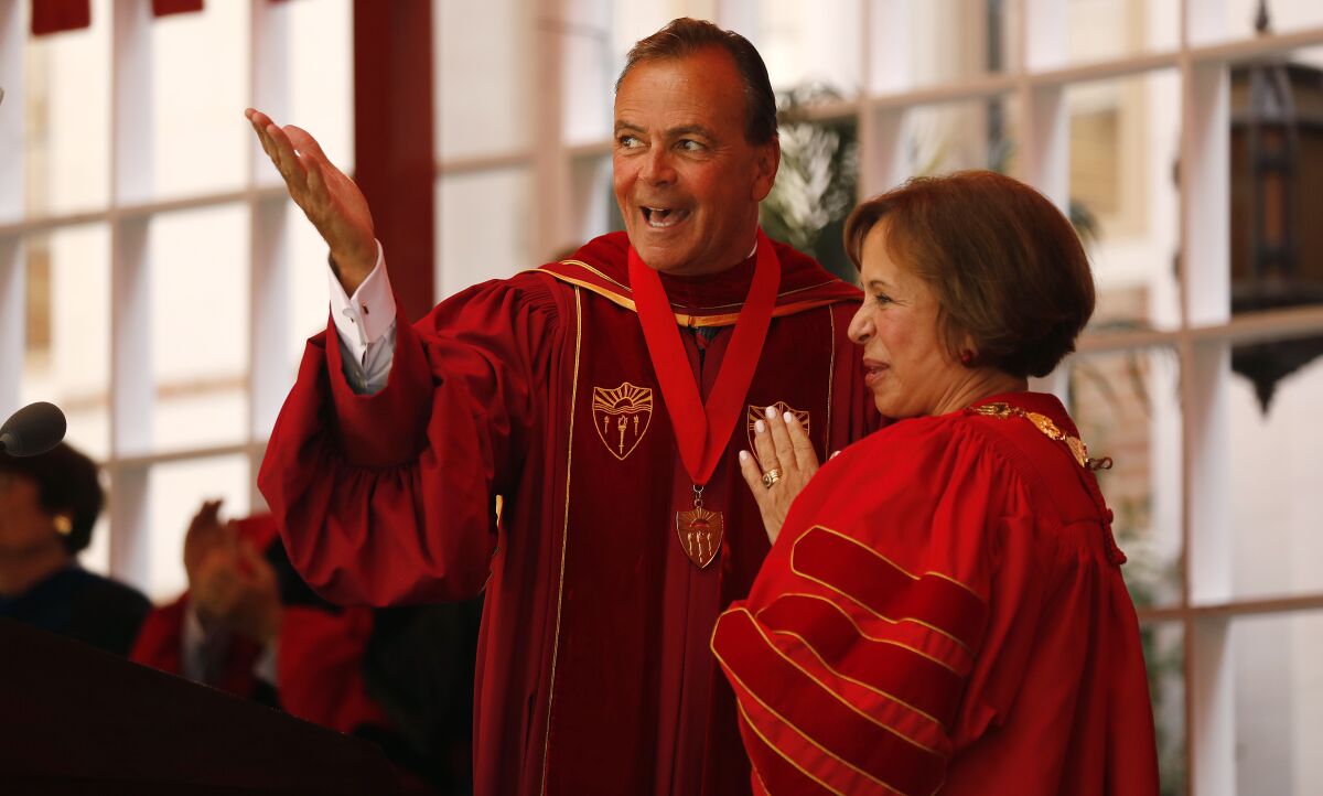Rick Caruso, left, with Dr.  Carol L. Folt at her 2019 inauguration as USC president.