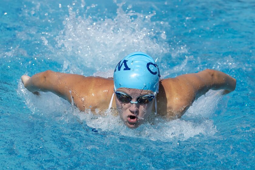 Corona del Mar's Maggie Schalow swims the butterfly leg of the 200 medley relay during the annual Battle of the Bay match at Newport Harbor High School on Tuesday, March 5.