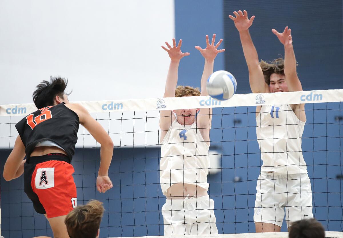 Colin Choi (10) of Huntington Beach is blocked by the defense of Corona del Mar's Brady Gant (4) and Sterling Foley (11).