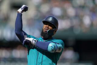 Seattle Mariners' Teoscar Hernandez gestures to the dugout after hitting an RBI single against the Los Angeles Angels during the fifth inning of a baseball game Wednesday, Sept. 13, 2023, in Seattle. (AP Photo/Lindsey Wasson)