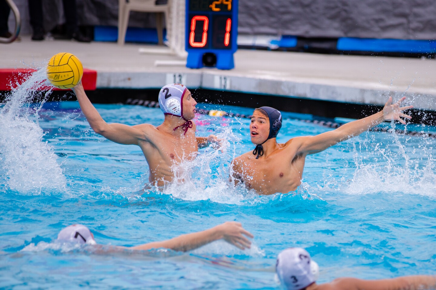 Zach Fales (2) shoots for The Bishop's School as La Jolla High's Crusoe Frapwell defends in Bishop's 13-9 water polo win.
